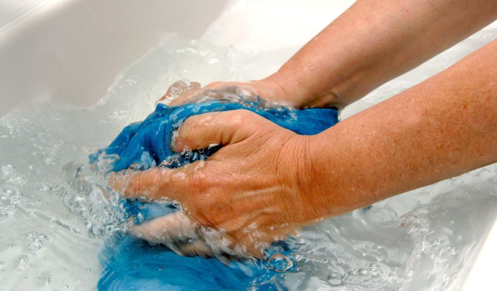 While hand washing clothes, keep rinsing until the water is clear